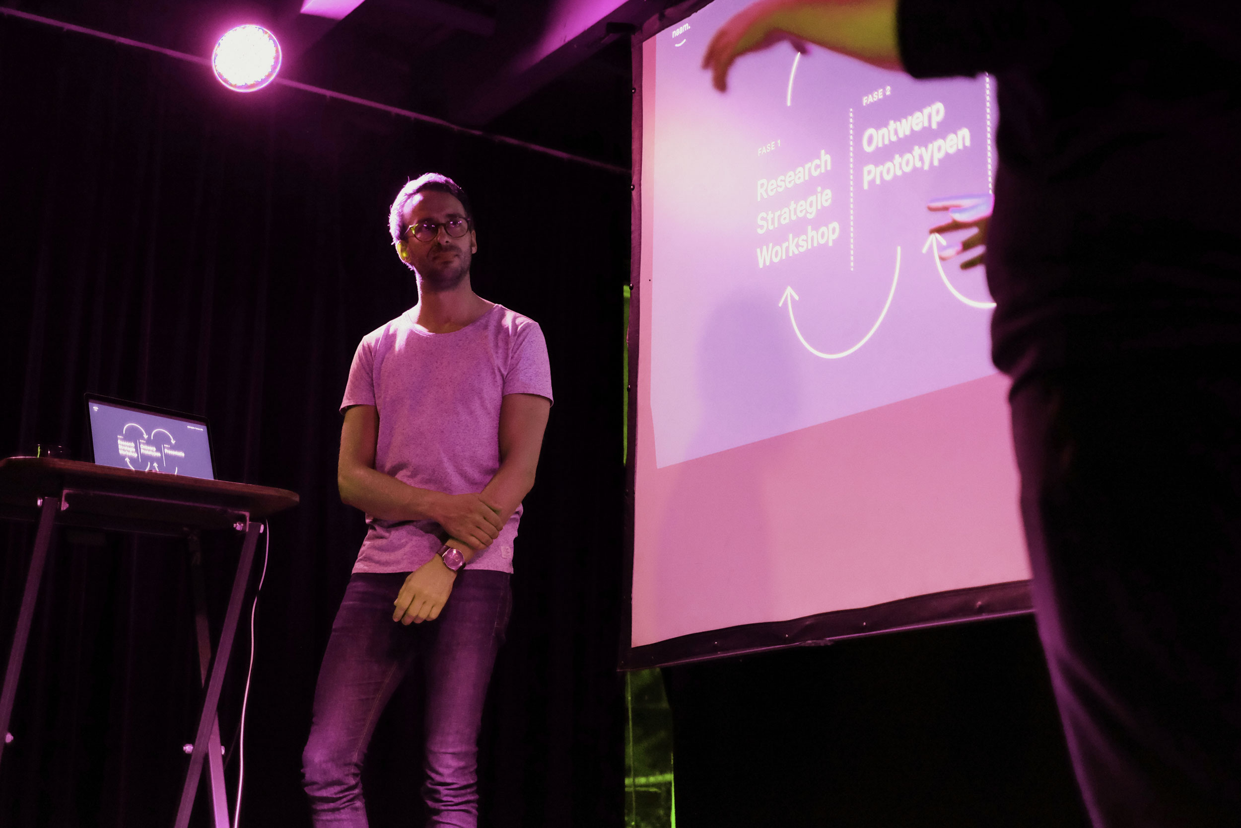 Two people speak about Naam's workflows on stage.