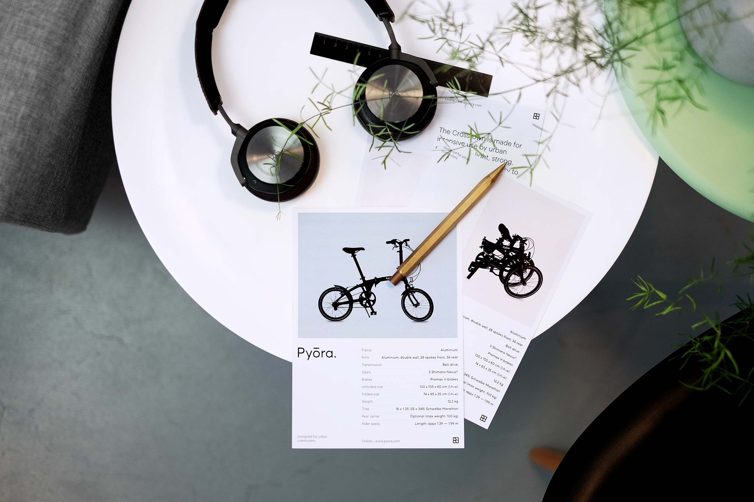 Two Pyora product flyers on small table with Beoplay H8